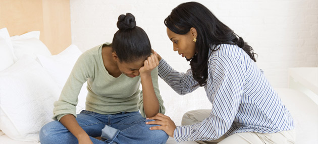 Woman consoling teenage girl