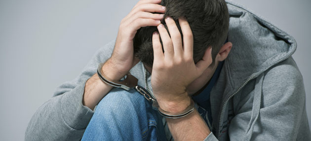 Teenage boy in handcuffs