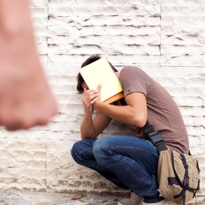 Teenager cowering from bully