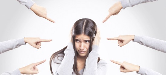 Fingers pointing at young woman