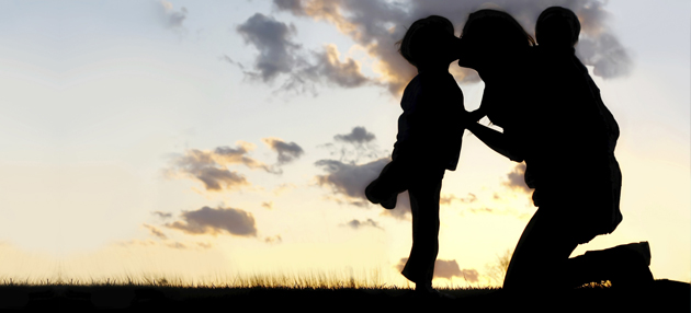 Mother embracing her two young children