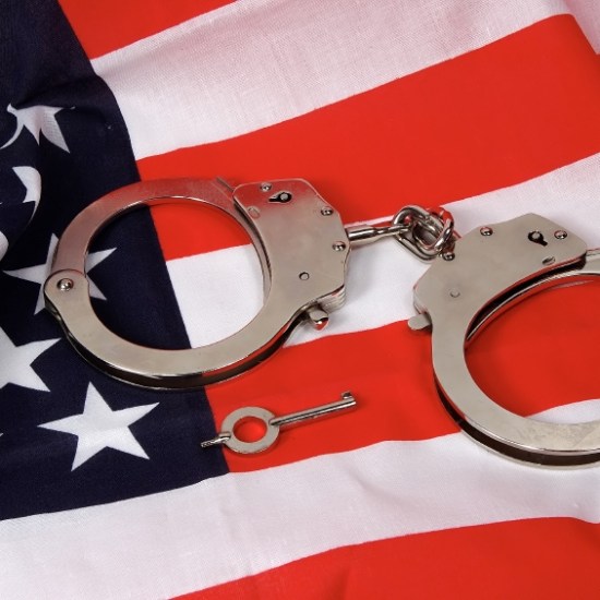 Handcuffs on top of the American flag