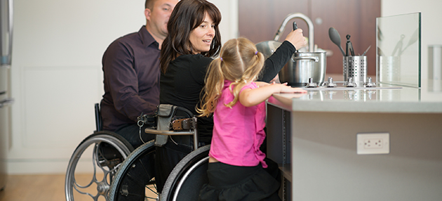 Disabled couple making dinner with their daughter