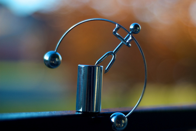 Balancing executive toy thrown off balance