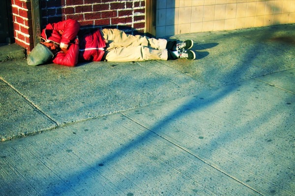 Homeless man sleeps on the street in NYC