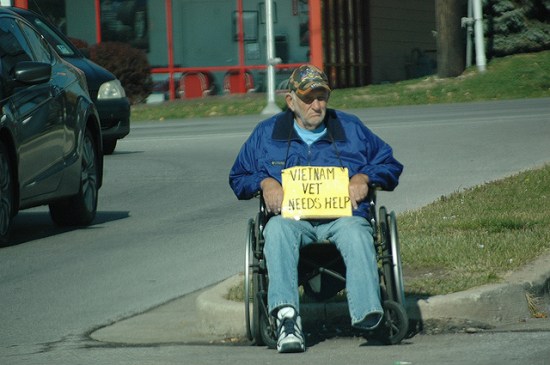 Homeless and disabled Vietnam veteran panhandles on the street