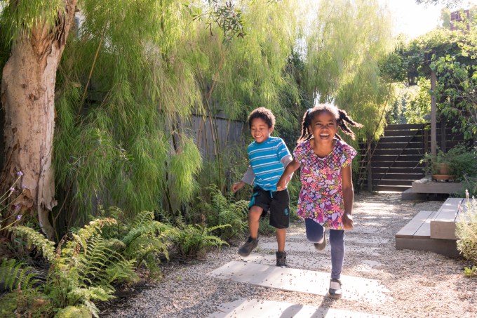 Carefree children running and playing in garden